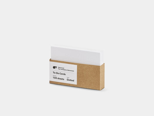 Box of to-do cards with a white card on top on a light gray background |-
