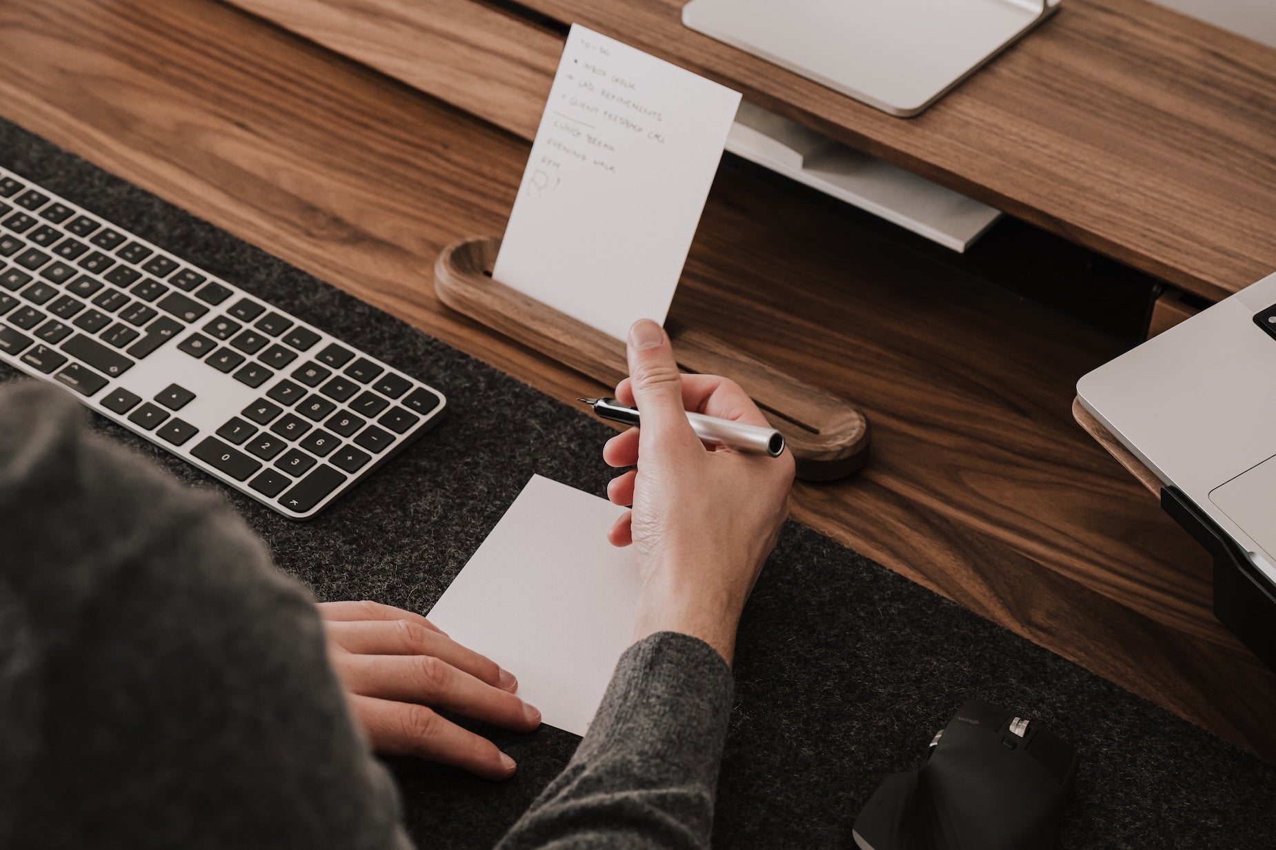 Person taking notes at a desk with oakywood to-do desk kit | walnut