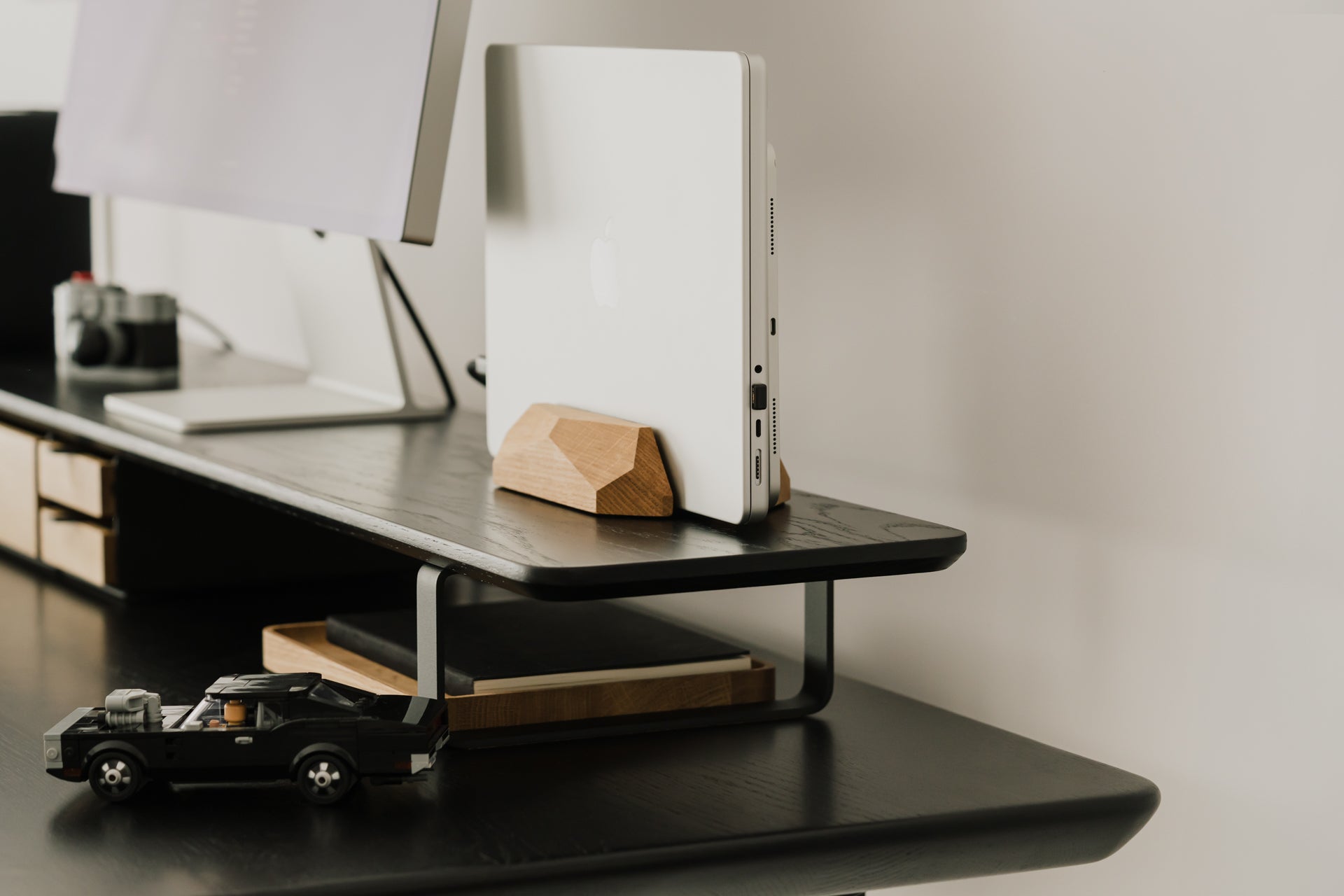 side view of black wooden desk shelf with additional accessories | black,