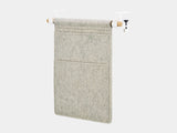 Oakywood Hanging Desk Organizer featuring stone grey felt pocket, oak rod and white clamps – minimalist hanging desk pocket for everyday essentials | stone grey, oak, white